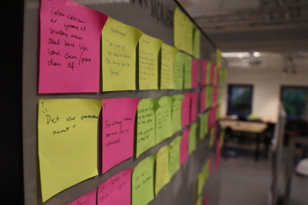 Whiteboard covered with colorful sticky notes from a personal development workshop