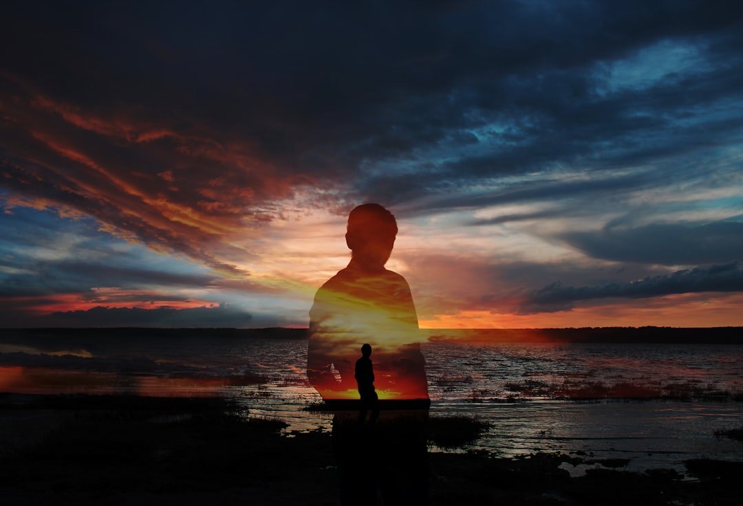 person meditating at sunrise